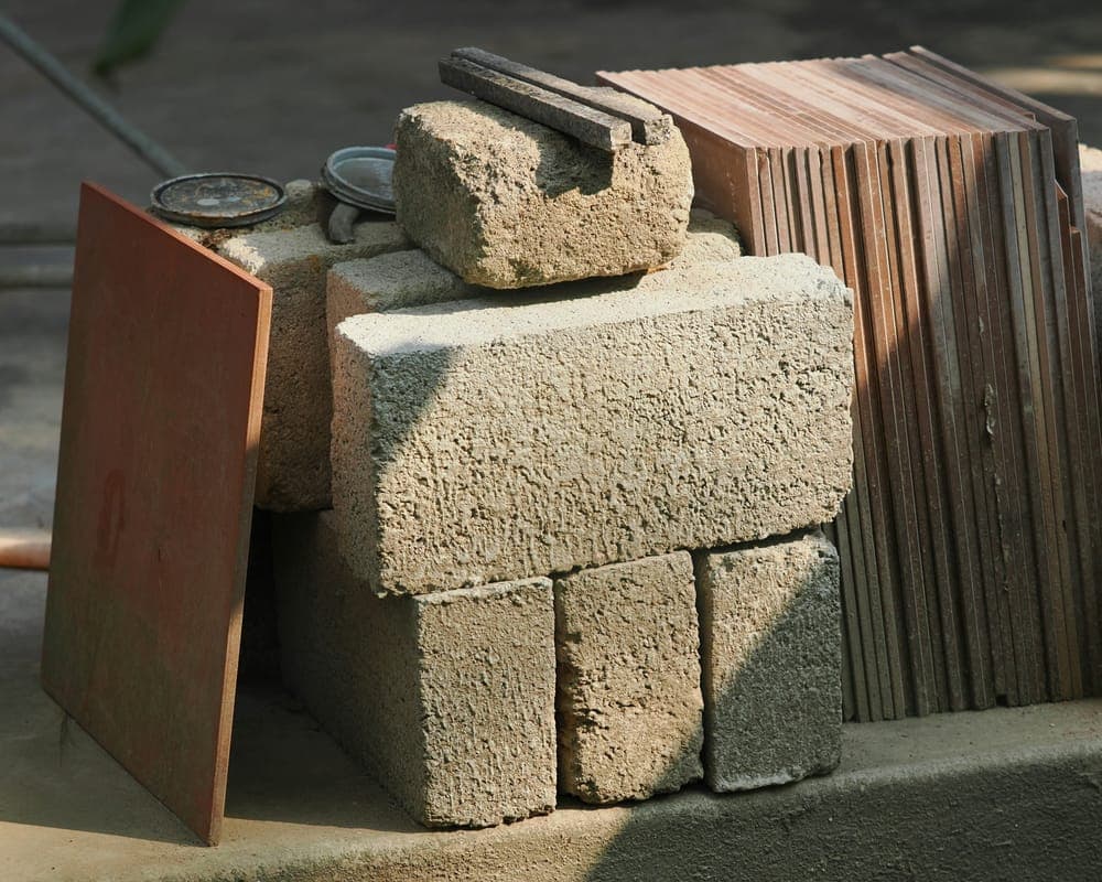 Stacked concrete blocks and timber on site