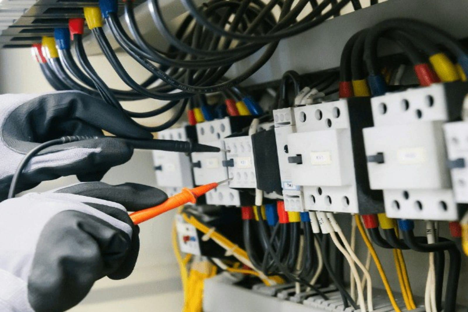 Electrician testing a panel during commissioning