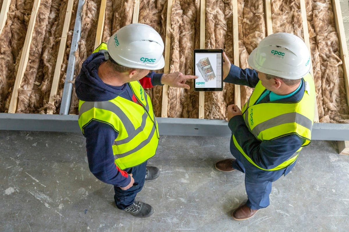 Site engineers reviewing drawings on a tablet